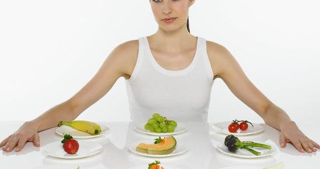 Woman with Variety of Fruits and Vegetables --- Image by © Serge Krouglikoff/zefa/Corbis