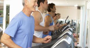 Senior Man On Running Machine In Gym