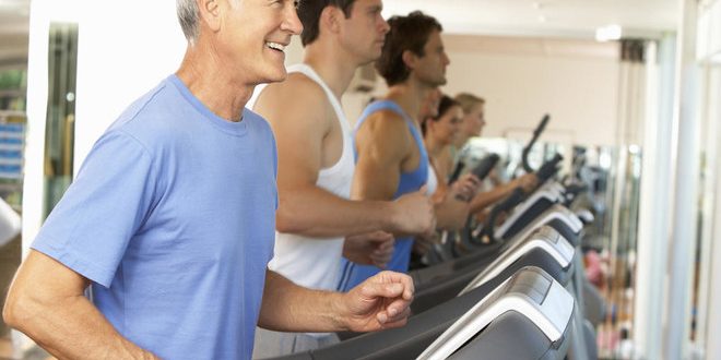 Senior Man On Running Machine In Gym