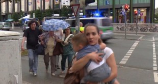 Members of the public run away from the Olympia Einkaufszentrum mall  after a shooting  in Munich  Germany  Friday  July 22  2016  A manhunt was underway Friday for a shooter or shooters who opened fire at a shopping mall in Munich  killing and wounding several people  a Munich police spokeswoman said  The city transit system shut down and police asked people to avoid public places   AP