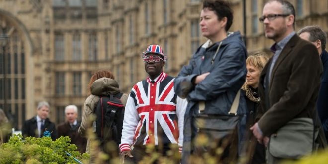 TOPSHOT - A man wearing clothing featuring the Union flag stands in front of the Houses of Parliament in London  on March 29  2017  shortly before British Prime Minister Theresa May announced to the House of Commons that Article 50 of the Lisbon Treaty had been triggered  formally starting Britain s withdrawl from the European Union  EU    Britain formally launched the process for leaving the European Union on March 29  a historic move that has split the country and thrown into question the future of the European project    AFP PHOTO   OLI SCARFF