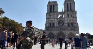 FILES  This file photo taken on August 15  2016 shows French soldiers patrolling in front of Notre Dame cathedral in Paris as part of the Sentinelle military force security mission while people queue for the mass for the feast of the Assumption on August 15  2016  French anti-terror police were holding two suspects on September 7  2016 after finding several gas cylinders in a car near Paris s Notre Dame cathedral  sources close to the investigation said  No detonators were found in the vehicle  which was discovered abandoned at the weekend  September 3 and 4  2016   the sources said  The car s owner and an associate  both known to police  were arrested on September 6  2016 they said  adding a preliminary investigation had been launched    AFP PHOTO   ALAIN JOCARD