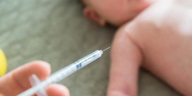 Close-up Of A Doctor Hand Vaccinating Baby