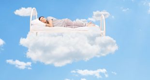 Man sleeping on a bed in the clouds high up in the sky